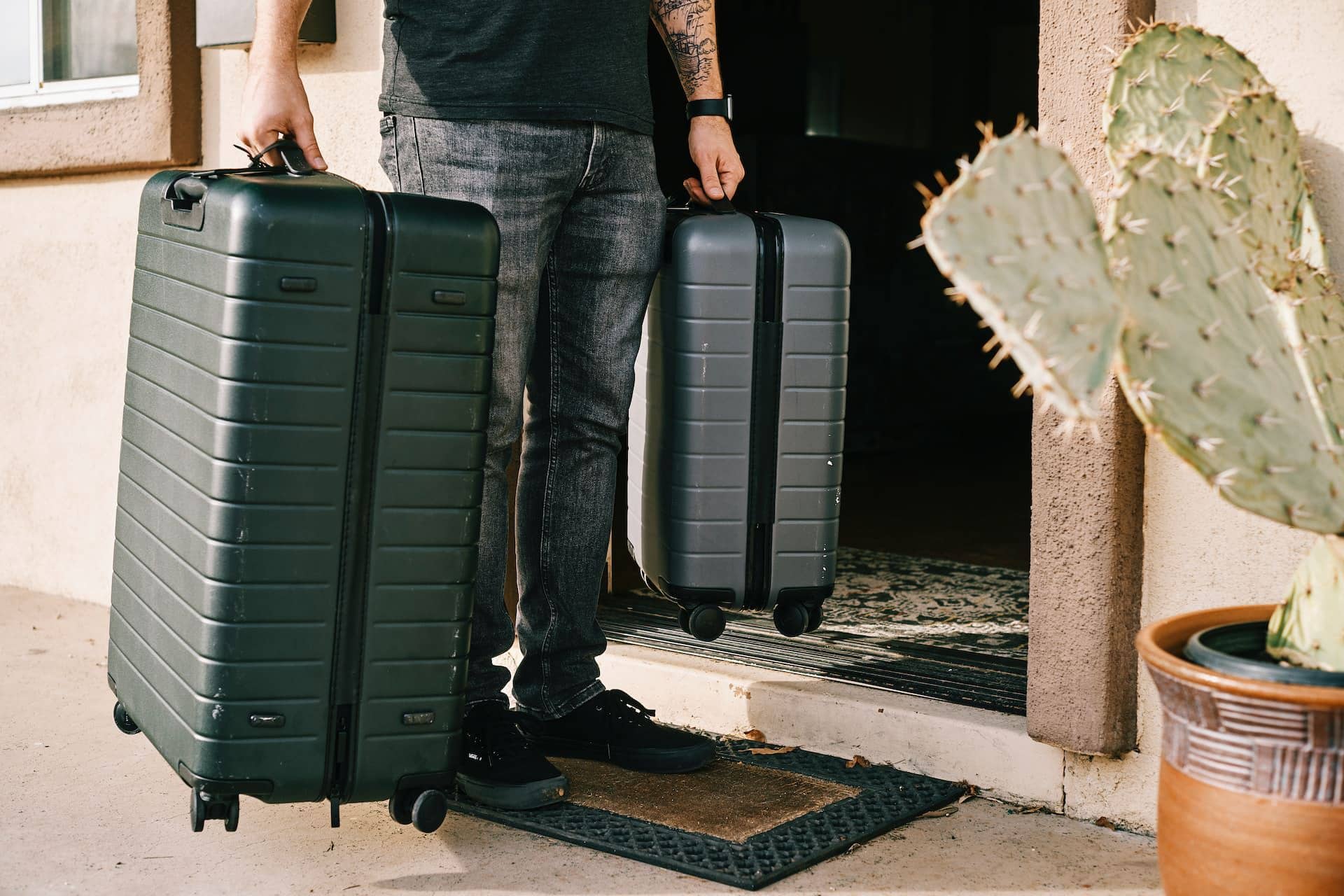 man holding two suitcases