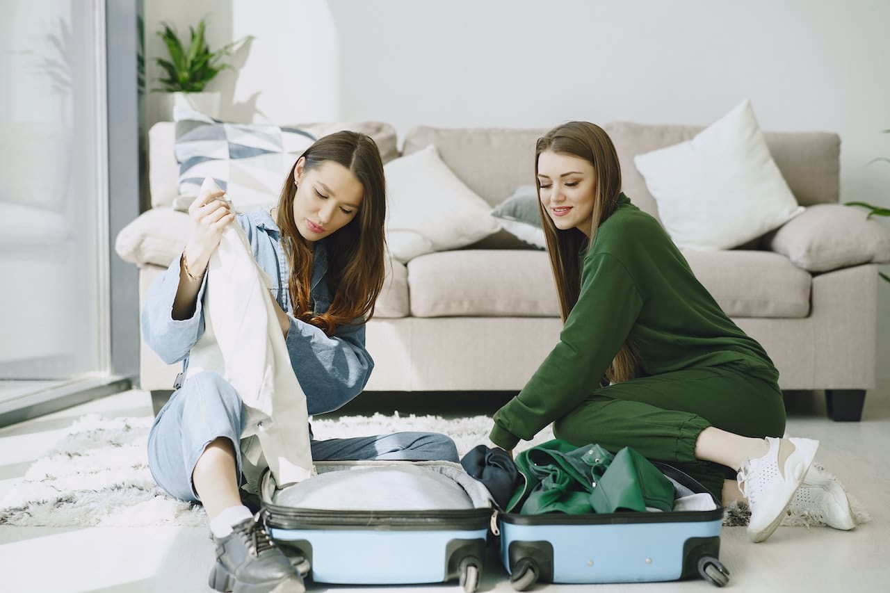 2 females packing elegant luggage