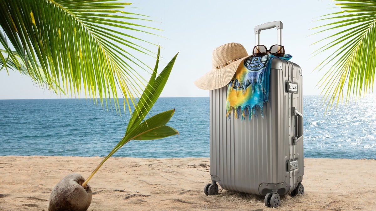 suitcase on sand for cruise